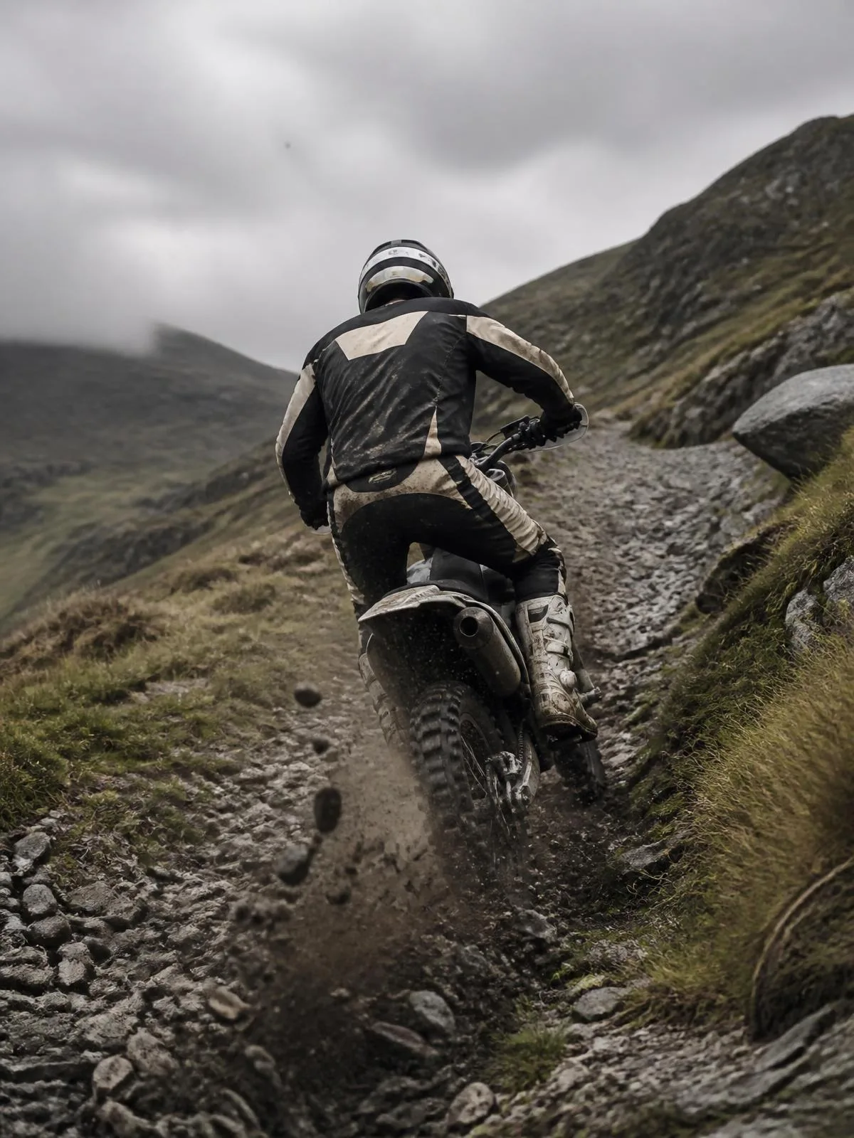 Enduro rider climbing a steep rocky trail
